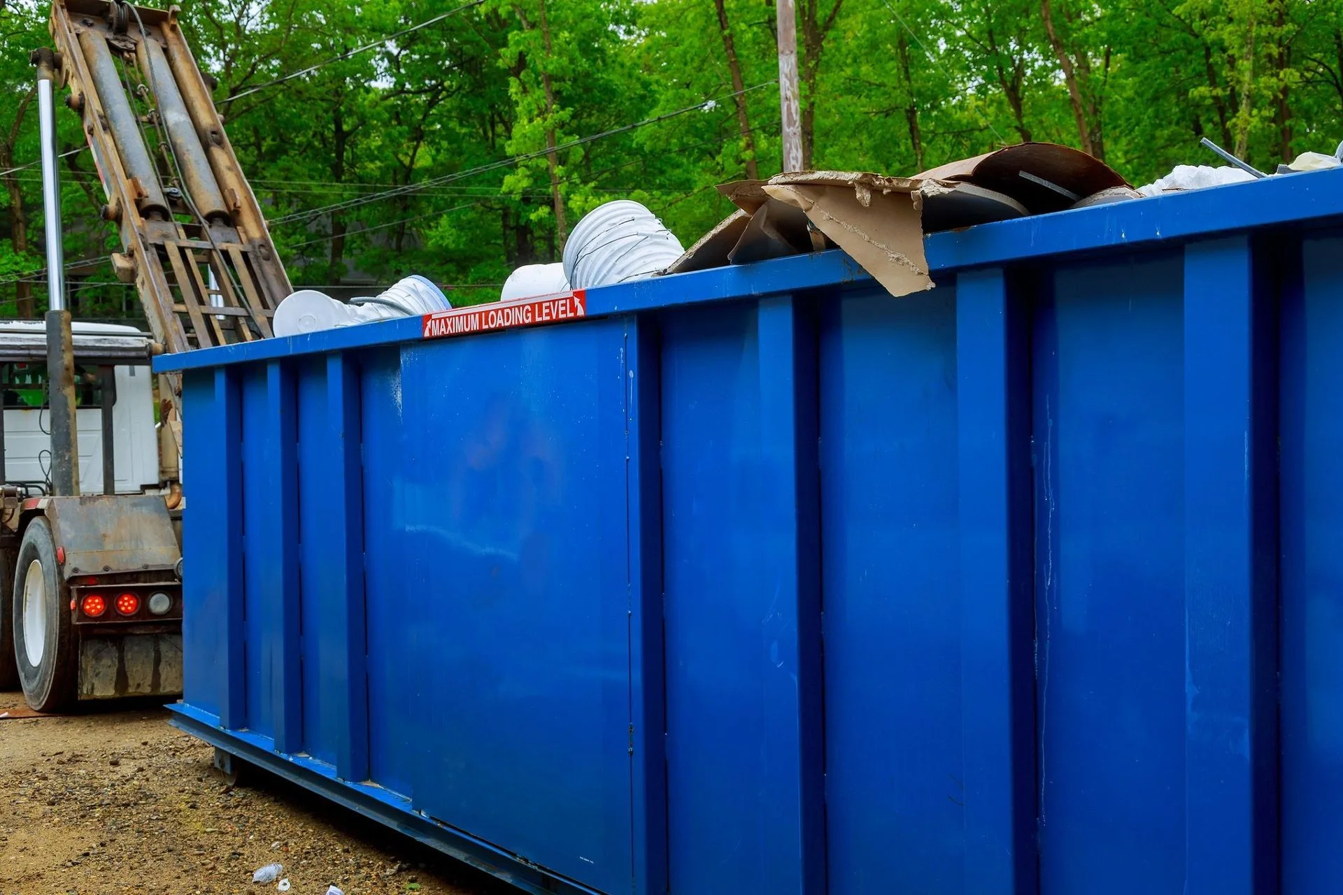 Blue roll-off container at a cleanup site
